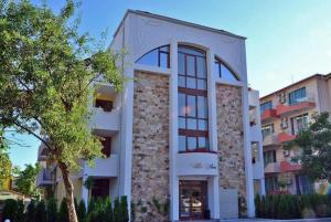 a white building with a tree in front of it at SP Luxury Loft 28 in Ravda
