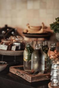 a group of three glass bottles on a wooden tray at OKU Ibiza in San Antonio