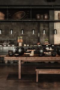a kitchen with pots and bowls on a wooden table at OKU Ibiza in San Antonio