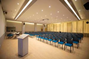 a large room with chairs and tables and a podium at Hotel Continental in Timişoara