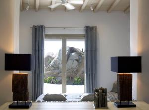 a bedroom with a bed and a large window at ABSOLUTE PARADISE in Paradise Beach