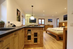 a kitchen with a sink and a bed in a room at Ferienwohnung Haus Hörth in Kreuth