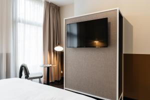 a hotel room with a flat screen tv on a wall at The Hunfeld in Utrecht
