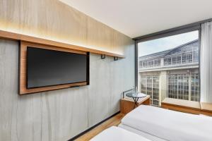 Postel nebo postele na pokoji v ubytování H2 Hotel Leipzig + 27 fotografií