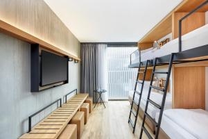 a row of bunk beds sitting next to each other at H2 Hotel Leipzig in Leipzig