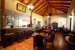 a restaurant with tables and chairs and a bar at Wild Cattle Creek Estate in Wandin Yallock
