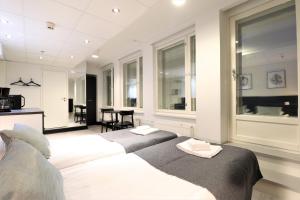 a bedroom with two beds with towels on them at Forenom Aparthotel Tampere in Tampere