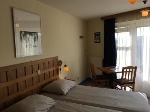 Postel nebo postele na pokoji v ubytování Carels Kamers Texel