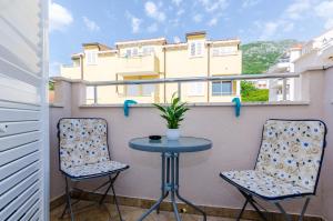 a small table and two chairs on a balcony at Ana Apartment in Cavtat