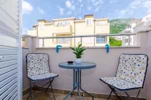 a small table and two chairs on a balcony at Ana Apartment in Cavtat