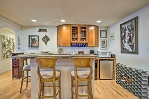 a kitchen with a large island with bar stools at Grand Junction Abode about 2 Miles to Wineries and Golf! in Grand Junction