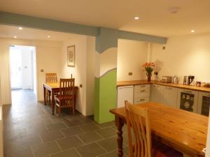 a kitchen with a table and a dining room at Highfield House, Parracombe, Modern B&B in Parracombe