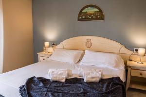 Posteľ alebo postele v izbe v ubytovaní Le Residenze di Santa Costanza - Le Dimore