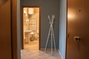 a bathroom with a door open and a shower stall at Residenze Santa Costanza in San Vincenzo