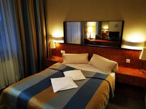 Postel nebo postele na pokoji v ubytování Hotel Passione