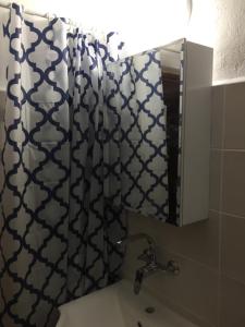 a bathroom with a shower curtain and a sink at Villa Draganovi in Kamen Bryag