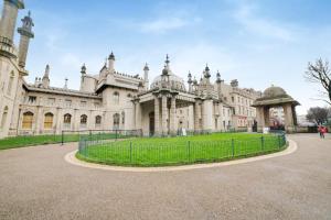 a large building with a fence in front of it at The Gullivers Hotel in Brighton & Hove