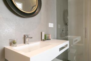 a bathroom with a white sink and a mirror at Teatro Romano 1 & 2 in Málaga