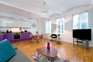 a living room with a couch and a table at Mulberry Flat 1 - One bedroom 1st floor by City Living London in London