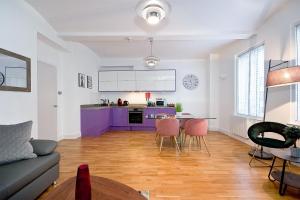 a living room with a couch and a table at Mulberry Flat 1 - One bedroom 1st floor by City Living London in London
