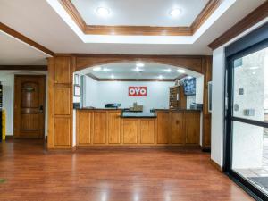 an empty lobby with a xo sign on the wall at OYO Hotel Irving DFW Airport North in Irving