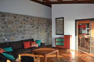 a living room with a couch and a table at Villa atypique le chat perché de Grand Anse in Petite Île +16 photos