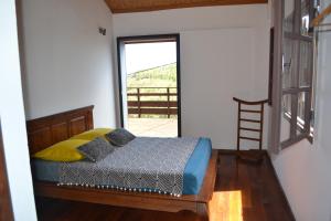 a bedroom with a bed in a room with a window at Villa atypique le chat perché de Grand Anse in Petite Île