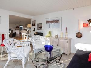 a living room with a glass table and chairs at 8 person holiday home in V ggerl se in Marielyst