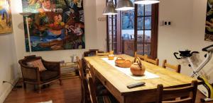a dining room with a wooden table and chairs at Tango Cozy Home in Buenos Aires