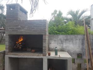 a brick oven with a fire inside of it at Novgorod in Aguas Dulces