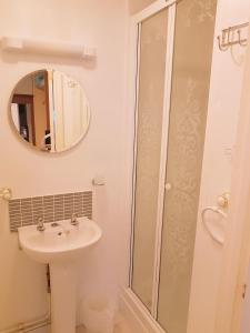 a bathroom with a sink and a shower at Philbeach Guest House in Weymouth