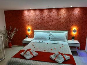 a bedroom with a large bed with a red wall at Red House in Naples