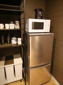 Kitchen o kitchenette sa TABISAI HOTEL Luxe 博多