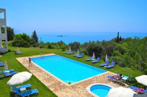 a large swimming pool with chairs and umbrellas at Galini Seaview Kontogialos in Pelekas
