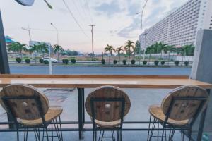 two chairs sitting at a bar with a view of a street at Life is Goood in Jomtien Beach
