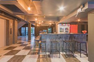 a bar with stools and a counter in a room at Life is Goood in Jomtien Beach