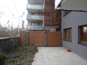 budynek z drewnianym płotem obok chodnika w obiekcie Apartament w centrum, garaż i jakuzzi w cenie we Wrocławiu