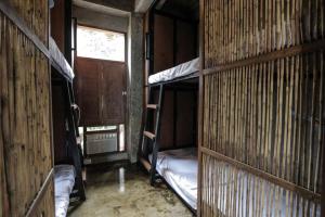 a room with two bunk beds and a window at Hang Loose Hostel in General Luna
