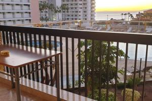 a balcony with a bench and a view of the ocean at Copacabana 2 in Playa Fañabe