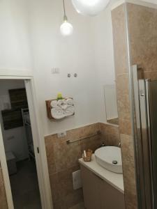 a bathroom with a sink and a toilet and a mirror at B&B Ninfa in Caserta