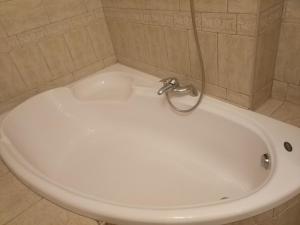 a white bath tub with a faucet in a bathroom at Apartment 2 rooms Lux near Inturist Prospect Soborniy in Zaporozhye