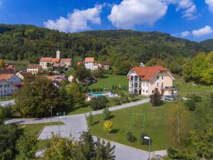 a village with a house and a playground at Vila Silva Marija Apartments in Pišece