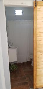 a bathroom with a sink and a toilet at La Soñada - cabañas in Cruz del Eje