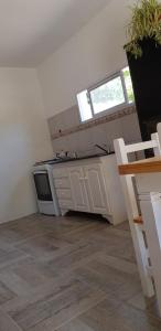 a kitchen with a stove and a counter top at La Soñada - cabañas in Cruz del Eje