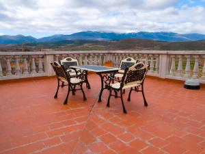 a table and chairs on a patio with a view at CASA RURAL VILLA DE VERA in Vera de Moncayo