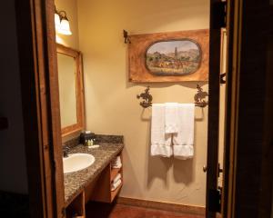 a bathroom with a sink and a mirror at Wildcatter Ranch and Resort in Graham