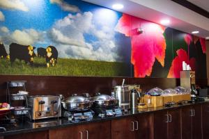 a kitchen with a large mural on the wall at Okatie Hilton Head Hotel in Bluffton