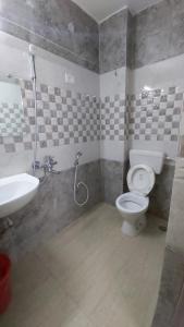 a bathroom with a toilet and a sink at Hotel Fortune in Patna