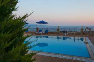 a swimming pool with a view of the ocean at Diana Studios in Trapezaki