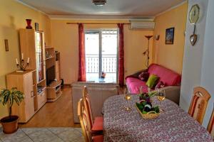 a living room with a table and a couch at Apartman Luna in Smokvica